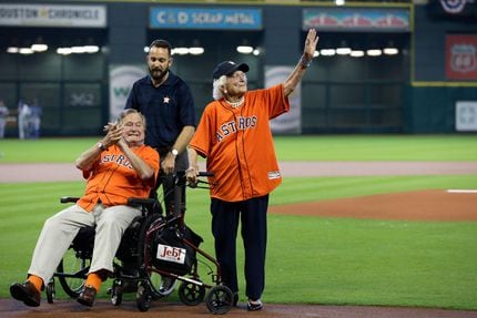 Former President George H.W. Bush along with wife Barbara prepares to throw out the...
