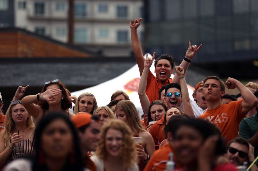 In a file photo, Longhorn fans celebrate while watching the University of Texas vs....