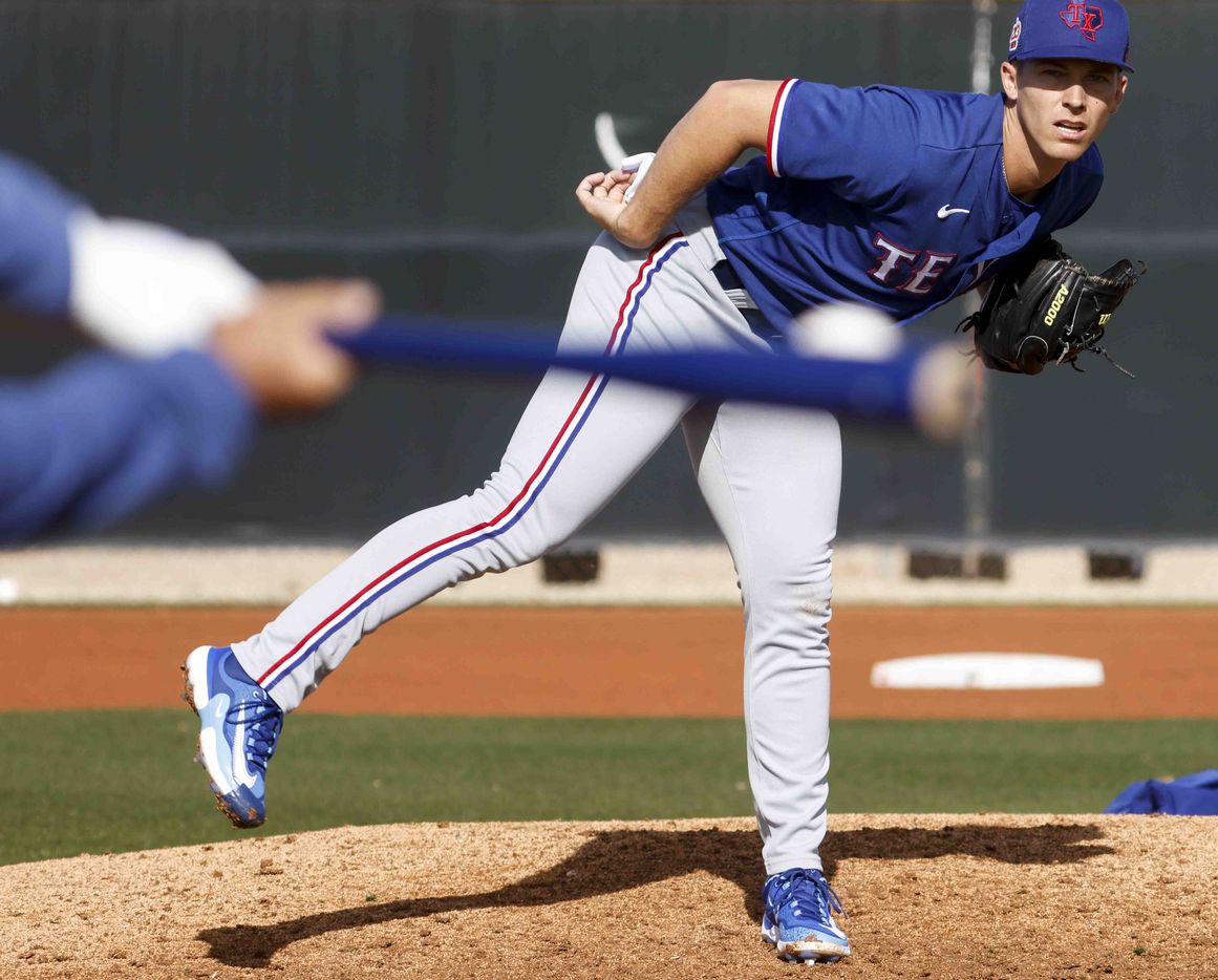 Texas Rangers pitcher Glenn Otto takes part in a fielding drill during a spring training...