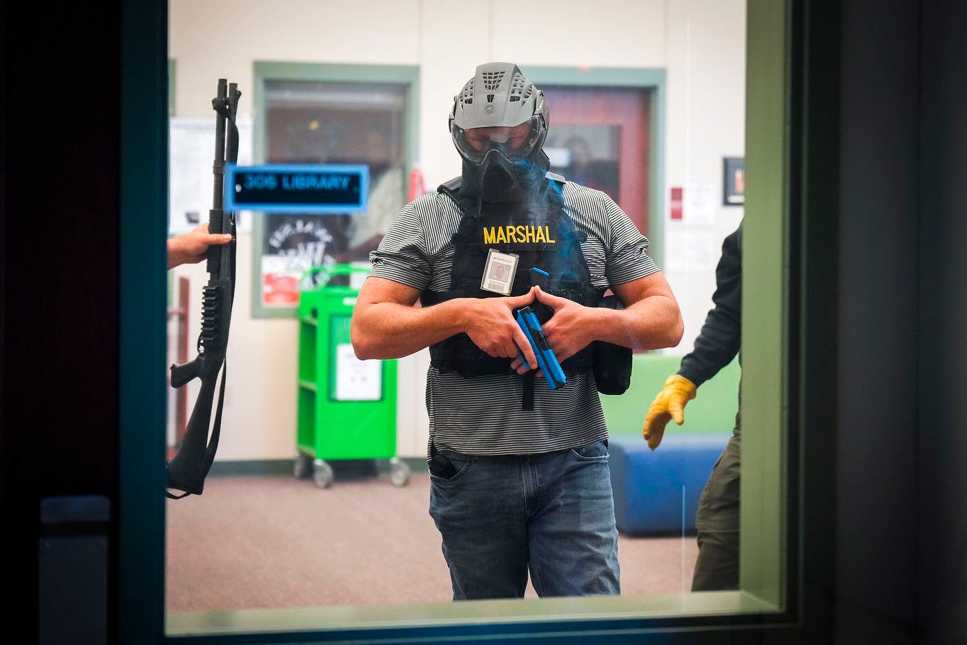 A school marshal participates in a school safety active shooter training demonstration...