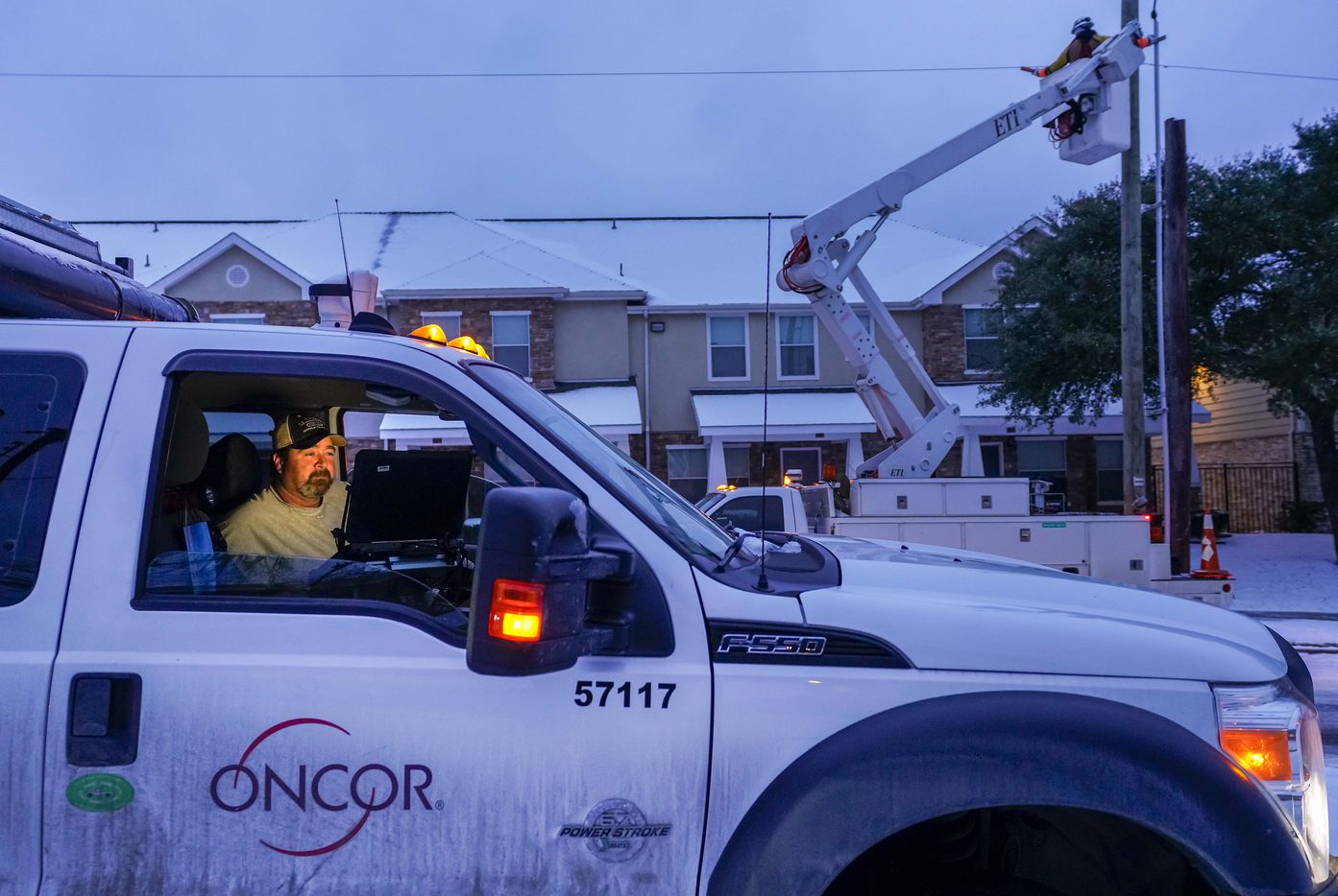 An Oncor crew works on along Elsie Faye Higgins Street as power outages continue across the state after a second winter storm brought more snow and continued freezing temperatures to North Texas on Wednesday, Feb. 17, 2021, in Dallas. (