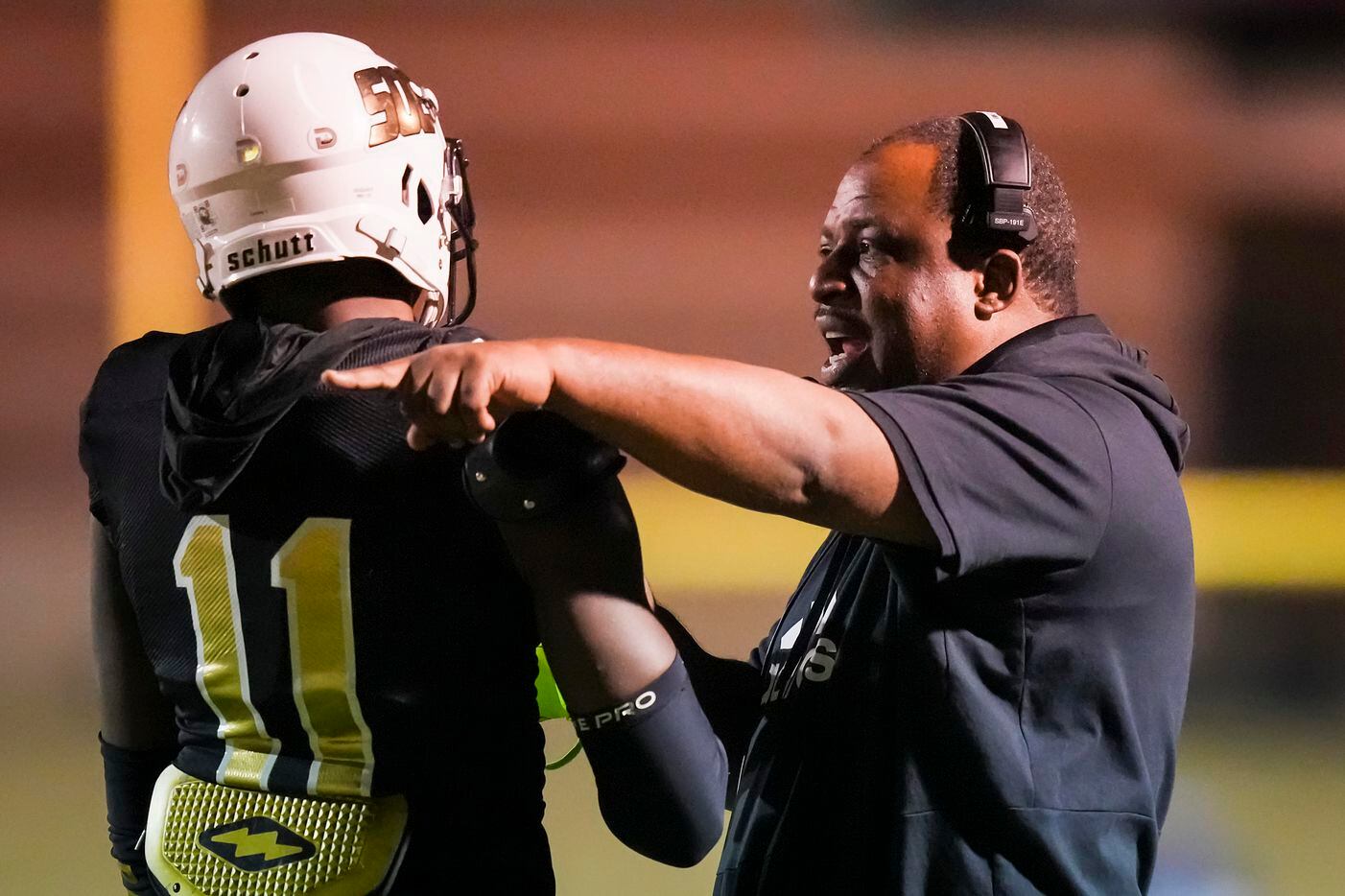South Oak Cliff head coach Jason Todd gives directions to wide receiver Jamyri Cauley (11)...