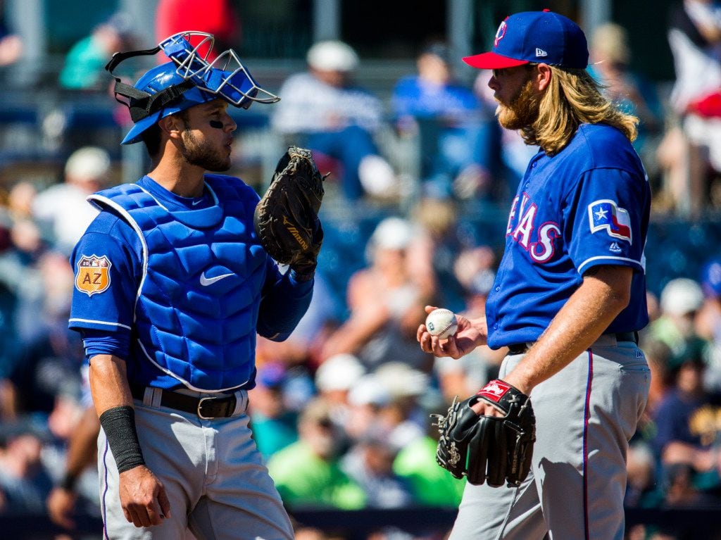 Texas Rangers catcher A.J. Jimenez (79) talks to starting pitcher A.J. Griffin (64) on the pitcher's mound during the fourth inning of a spring training game against the Seattle Mariners on Sunday, March 5, 2017 at the Peoria Sports Complex in Peoria, Arizona. (Ashley Landis/The Dallas Morning News)