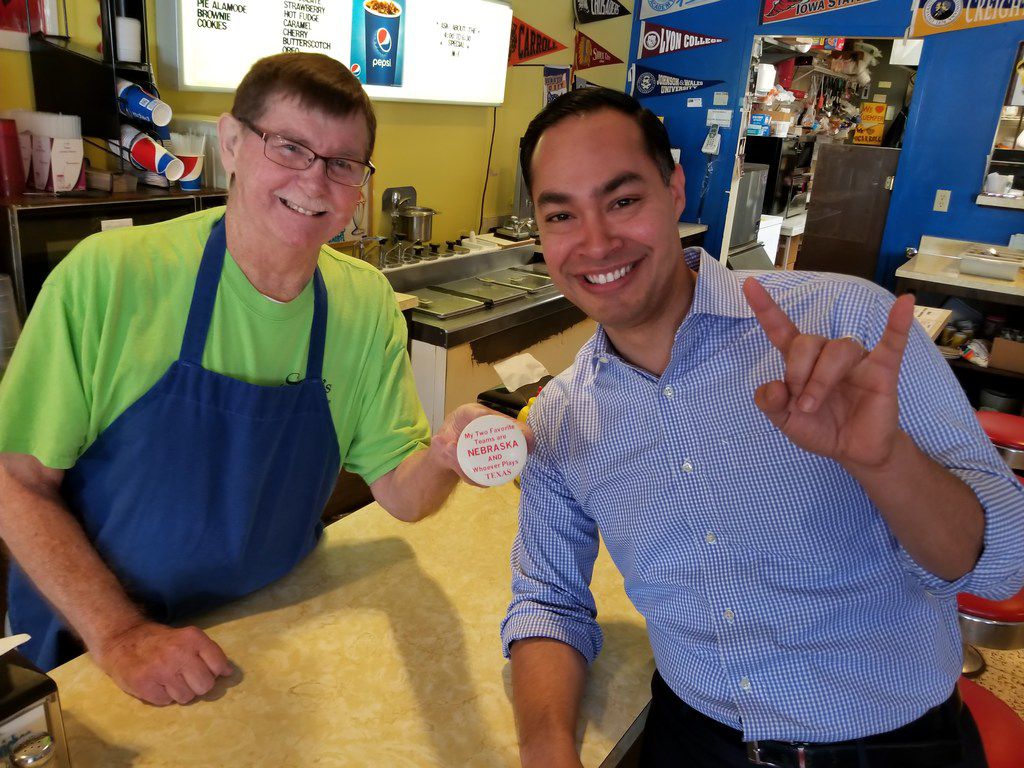 Julián Castro, stumping for president in Carroll, Iowa, poses with Sam Barta, owner of Sam's...