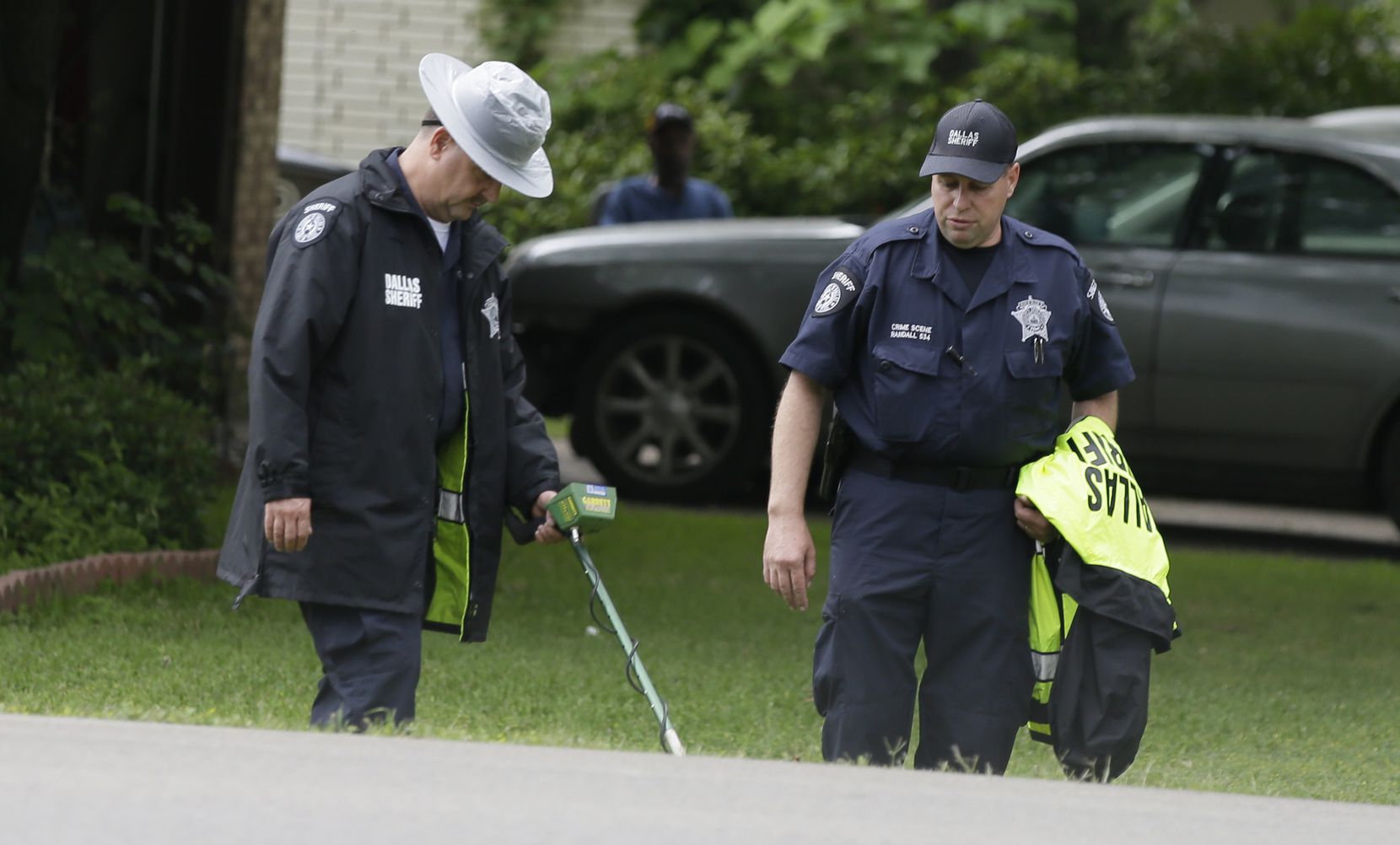 Dallas County Sheriff crime scene investigators use a metal detector at the intersection near where Jordan Edwards was killed by a police officer in Balch Springs, Texas, Wednesday, May 3, 2017. 