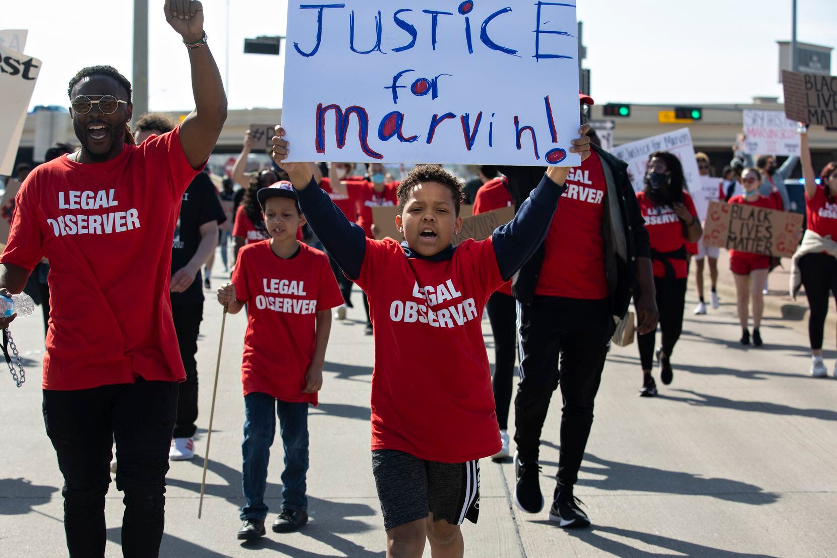 Elijah Lyons, 9, leads a march out of the Allen Outlets on Sunday, March 21, 2021 demanding...