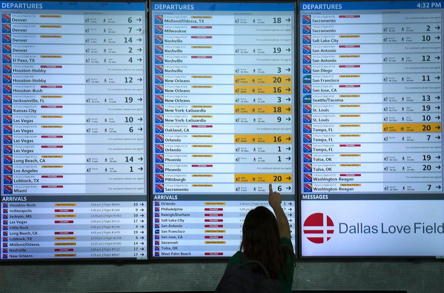 Flight status boards show Southwest flights either cancelled or delayed up and down the...
