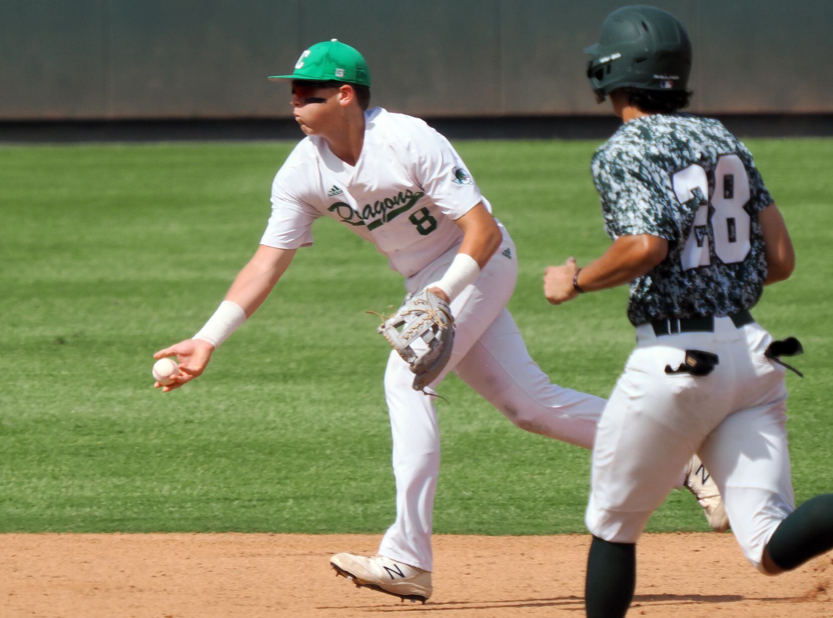 Southlake Carroll second baseman Ben Tryon (8) tosses to second for an out against San...