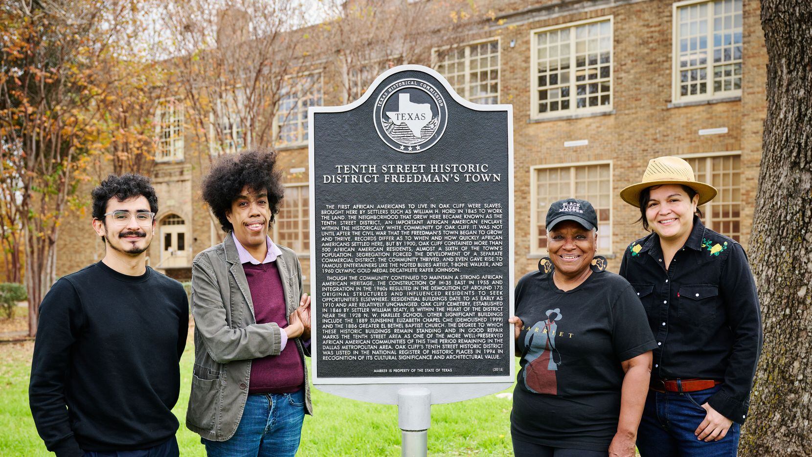Standing alongside the historical marker for the Tenth Street Historic District freedman's...
