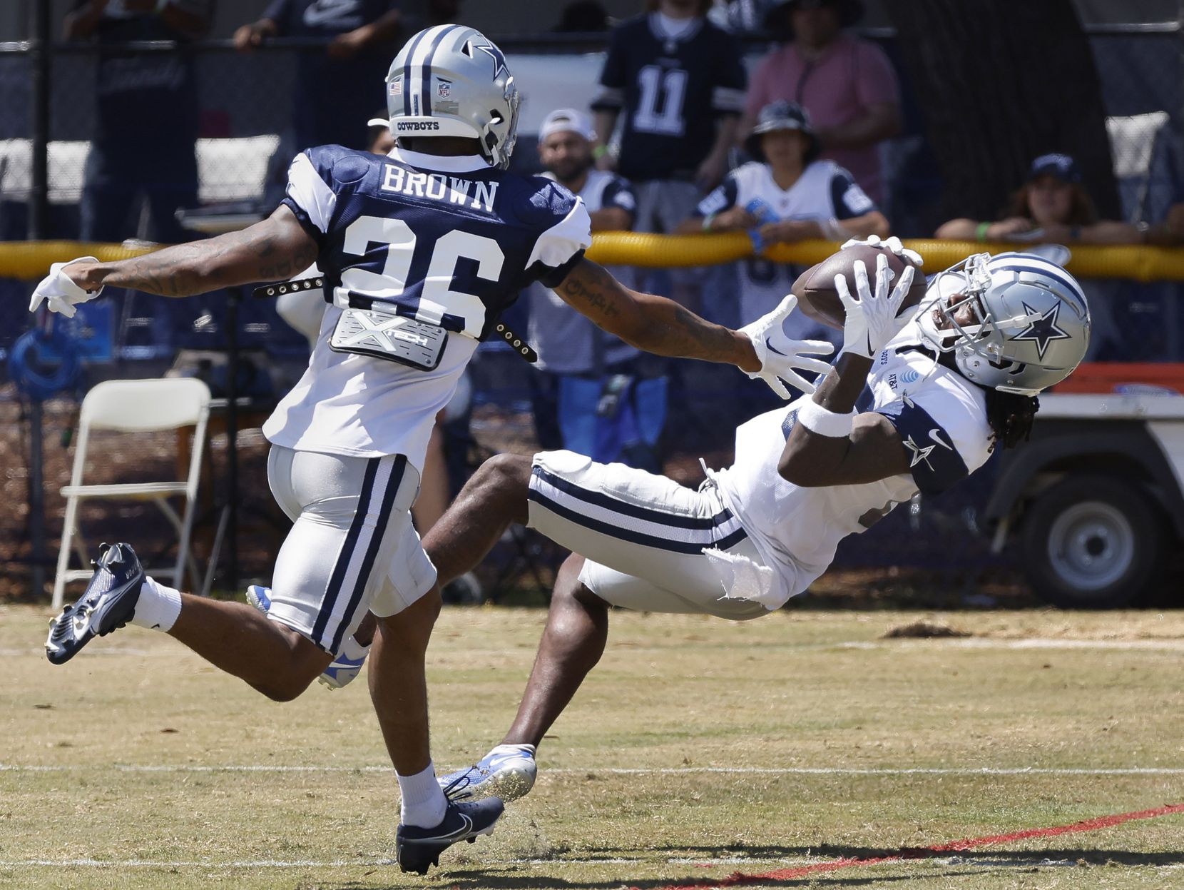 Dallas Cowboys wide receiver Noah Brown (85) falls backwards as he catches a deep...
