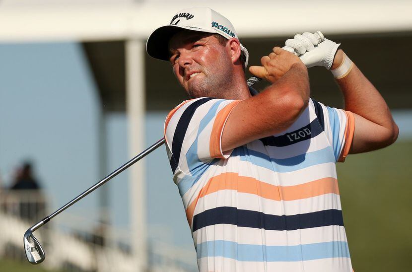 Marc Leishman, of Melbourne, Australia, tees off on the 17th hole during the first round of...