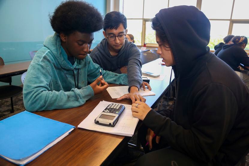 From left, Jason Burrell, 17; Rishan Zaman, 16, and Brian Lam, 16, work together in a...