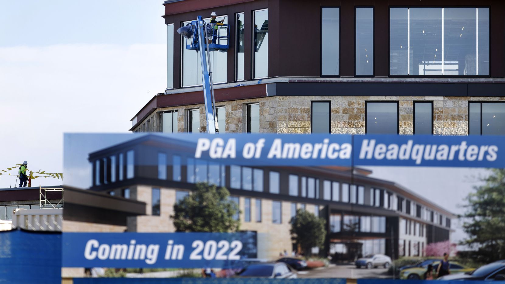 Construction crews work on the exterior of the new PGA of America Headquarters in Frisco,...