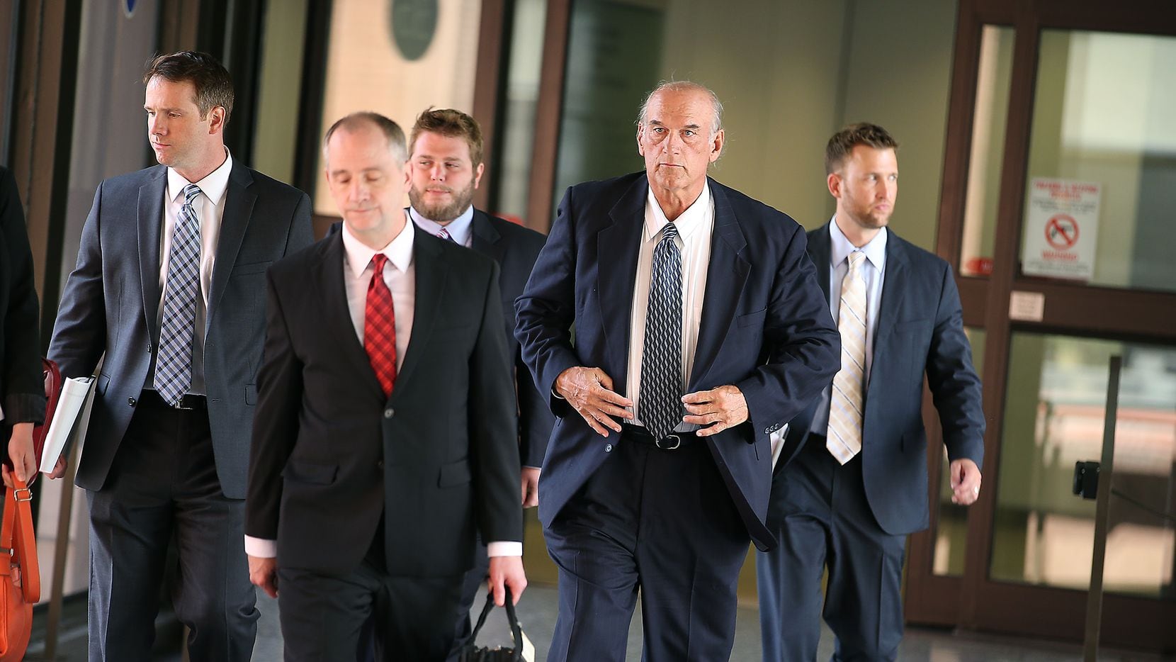 Former Minnesota Governor Jesse Ventura, second from right, makes his way out of the Warren...