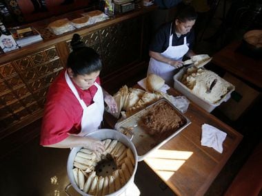 Maria Milan and Armandina Flores prepare tamales to sell for the holidays at Luna's Tortilla...