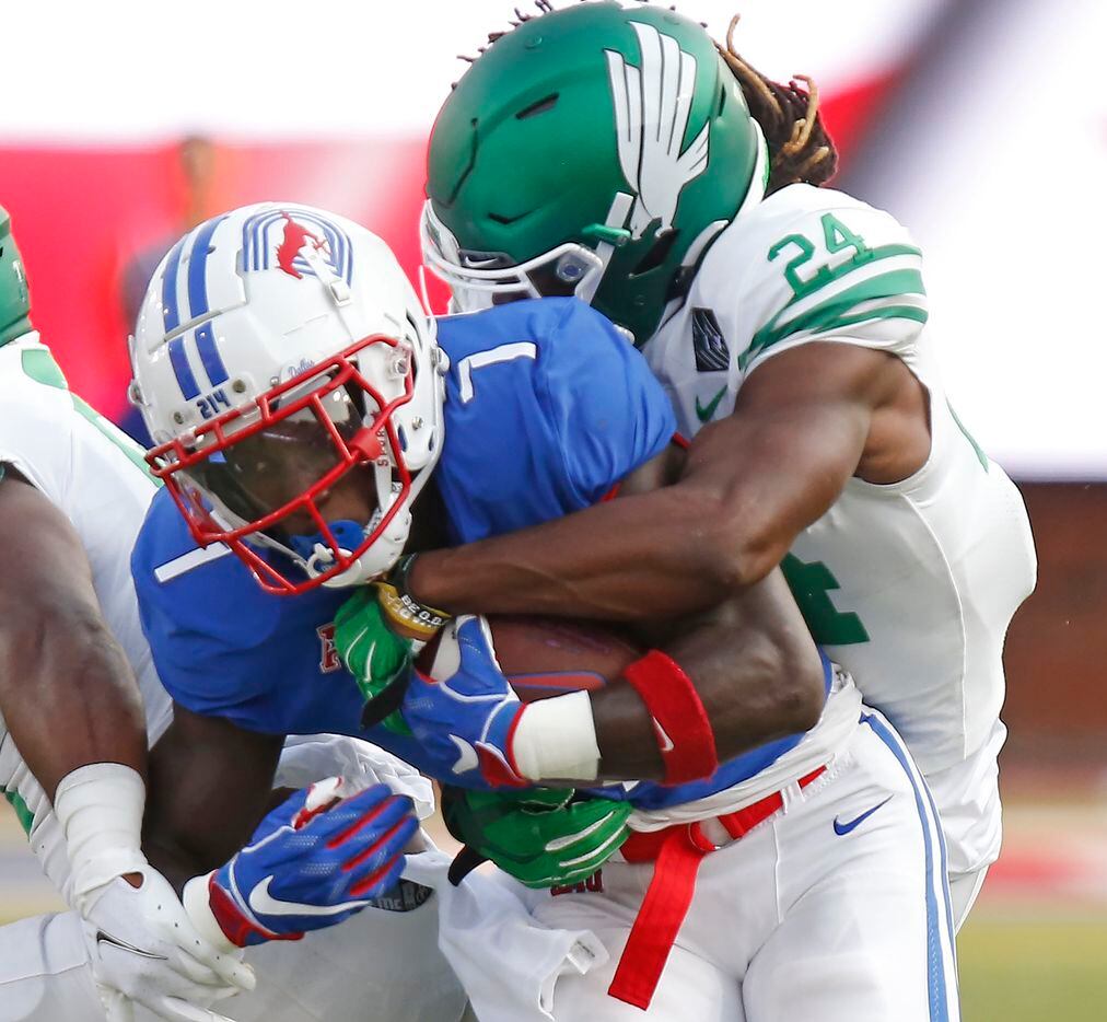 Southern Methodist Mustangs running back Ulysses Bentley IV (7)  is tackled by North Texas Mean Green linebacker Kevin Wood (21) during the first half as SMU hosted UNT at Ford Stadium in Dallas on Saturday, September 11, 2021. (Stewart F. House/Special Contributor)