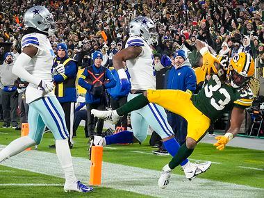 Green Bay Packers running back Aaron Jones (33) scores on a touchdown  run past Dallas...