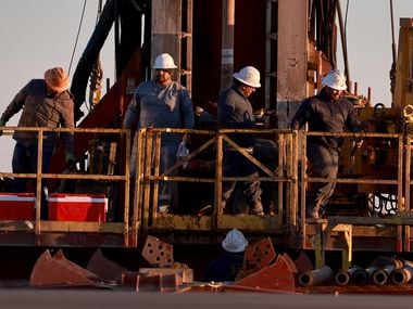 Workers on an oil drilling rig setup in the Permian Basin oil field on March 12, 2022, in...