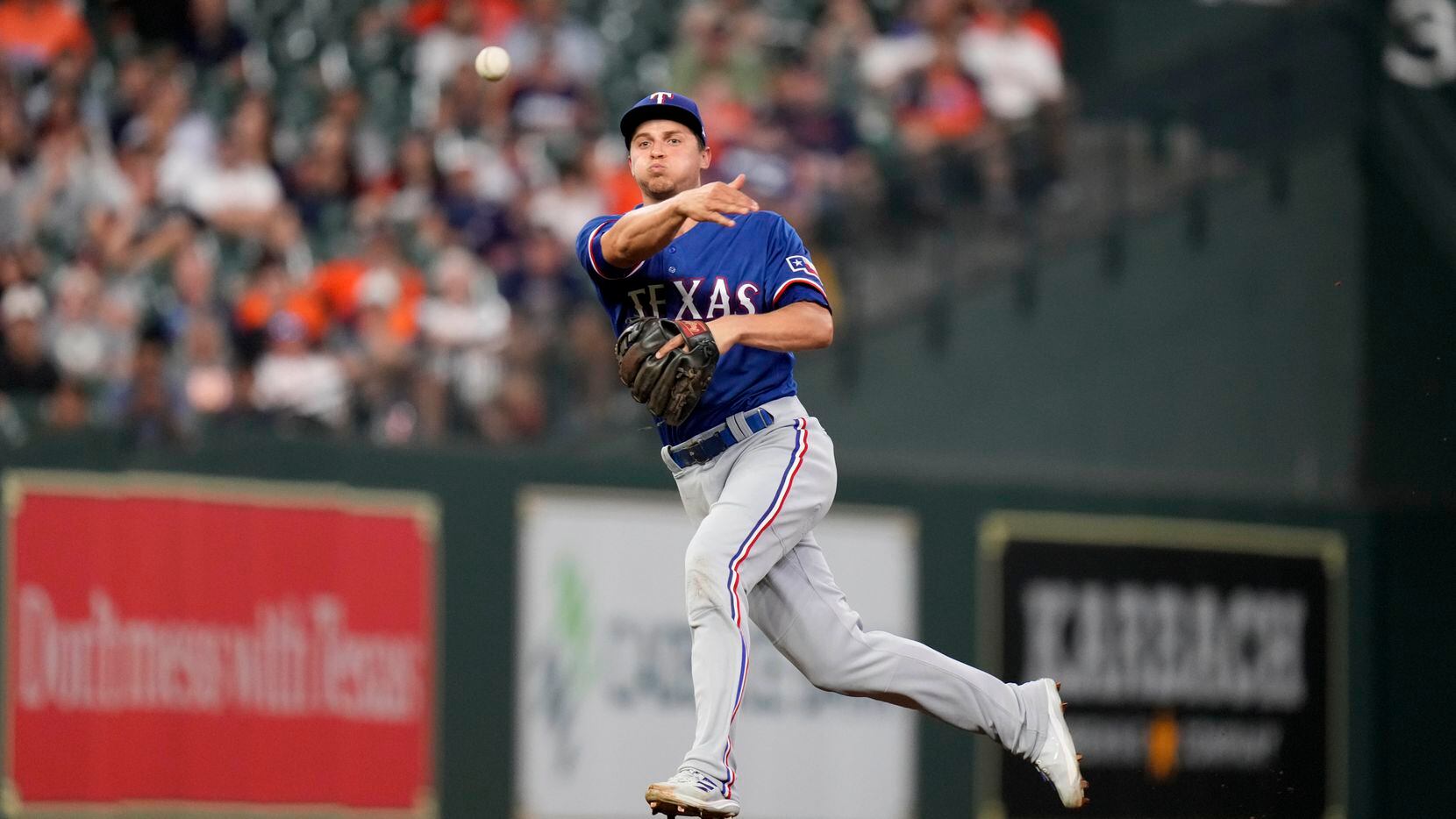 Texas Rangers shortstop Corey Seager attempts to throw out Houston Astros' J.J. Matijevic,...