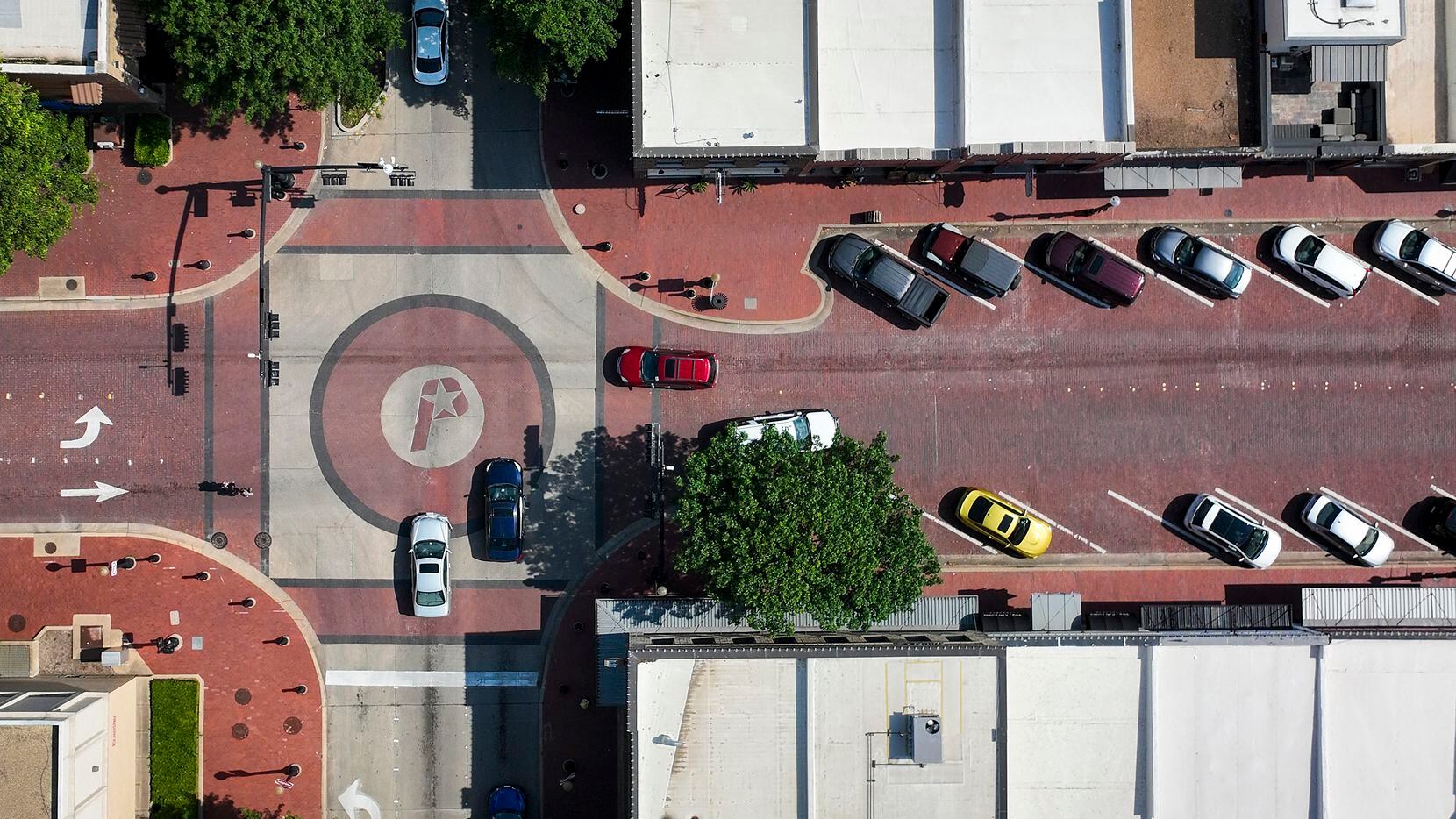 Traffic passes the city logo in the intersection of E. 15th and Avenue K on Wednesday, May...