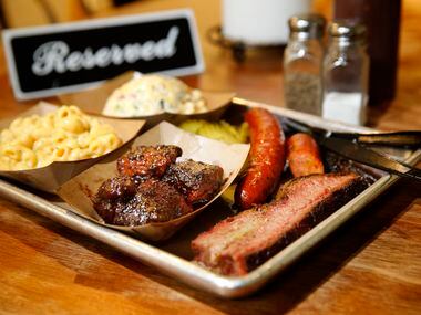 A tray full of brisket, burnt ends, sausage, green chile mac & cheese, and twice baked potato salad are pictured at Heim Barbecue in Fort Worth. The restaurant announced it will expand to Dallas in summer 2020.