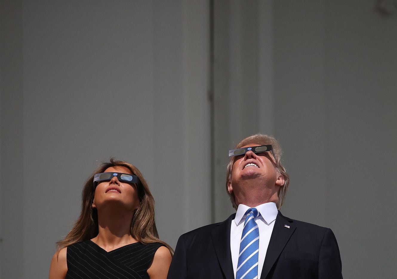 President Donald Trump and first lady Melania Trump wear special glasses to view the solar eclipse at the White House in Washington, DC. 