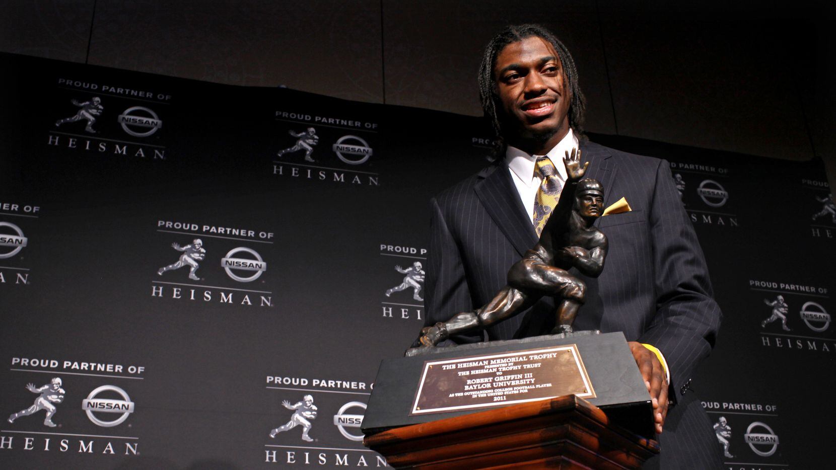 Heisman Trophy winner Robert Griffin III, of Baylor, is photographed with the award during a...