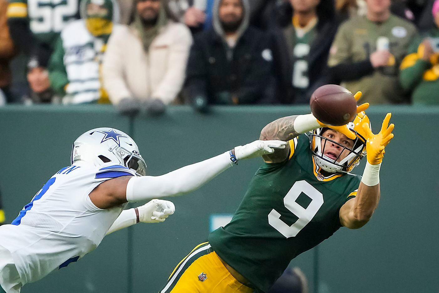 Green Bay Packers wide receiver Christian Watson (9) catches a pass as Dallas Cowboys...
