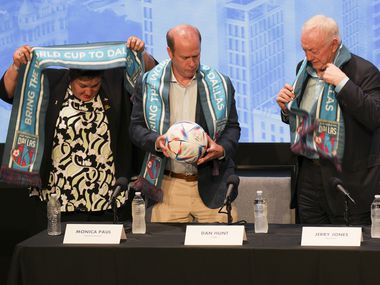 Monica Paul (from left), Dan Hunt and Jerry Jones don Dallas World Cup scarves during a...