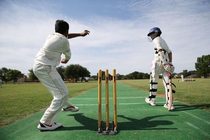 File photo of two cricket players practicing at Horseshoe Park in Plano.