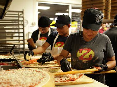 Employees prepare a steady flow of pizzas during a 2 a.m. rush at Zalat Pizza on Fitzhugh Avenue in Dallas.
