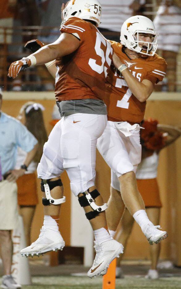 Texas quarterback Shane Buechele (7) celebrates a fourth quarter touchdown with offensive...