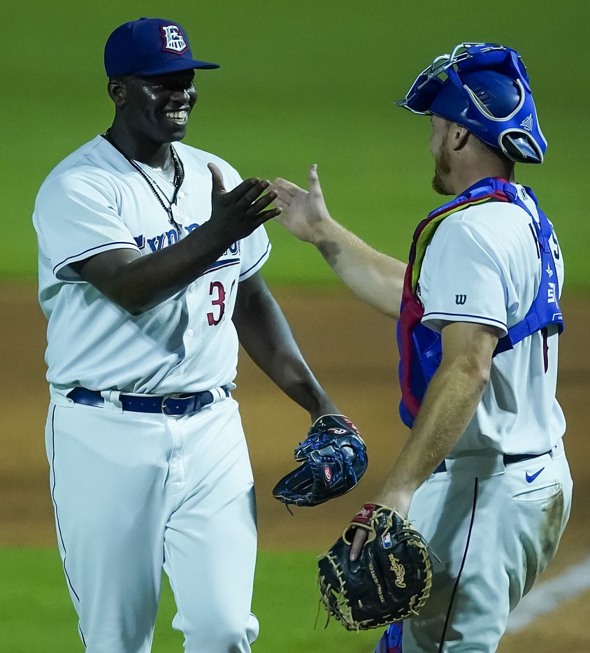 Round Rock Express pitcher Demarcus Evans celebrates with catcher John Hicks after the final...