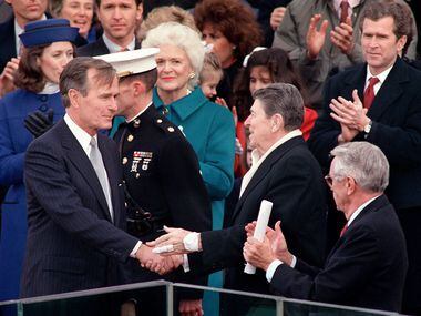 Outgoing President Ronald Reagan greets newly inaugurated President George H.W. Bush as...