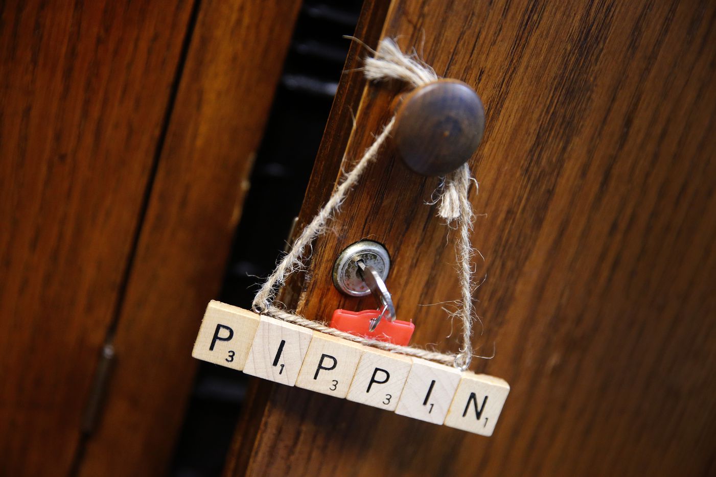 A Scrabble-lettered tag for Pippin hangs from a storage cabinet handle at The Firehouse...