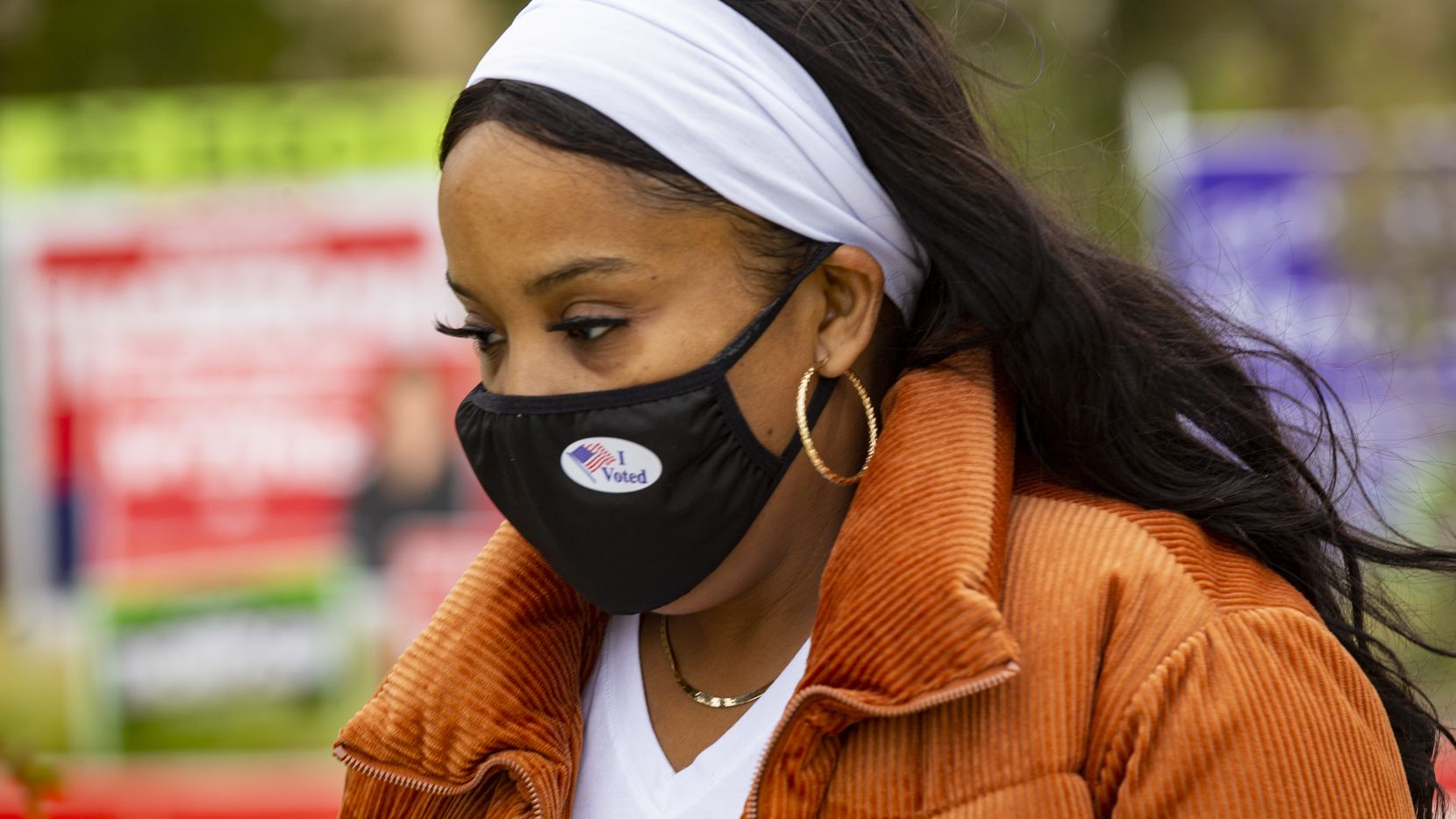 Wanda Brooks wears an "I voted" sticker on her mask after voting at the Collin College...