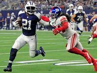 Dallas Cowboys running back Ezekiel Elliott (21) takes a reception around New York Giants...