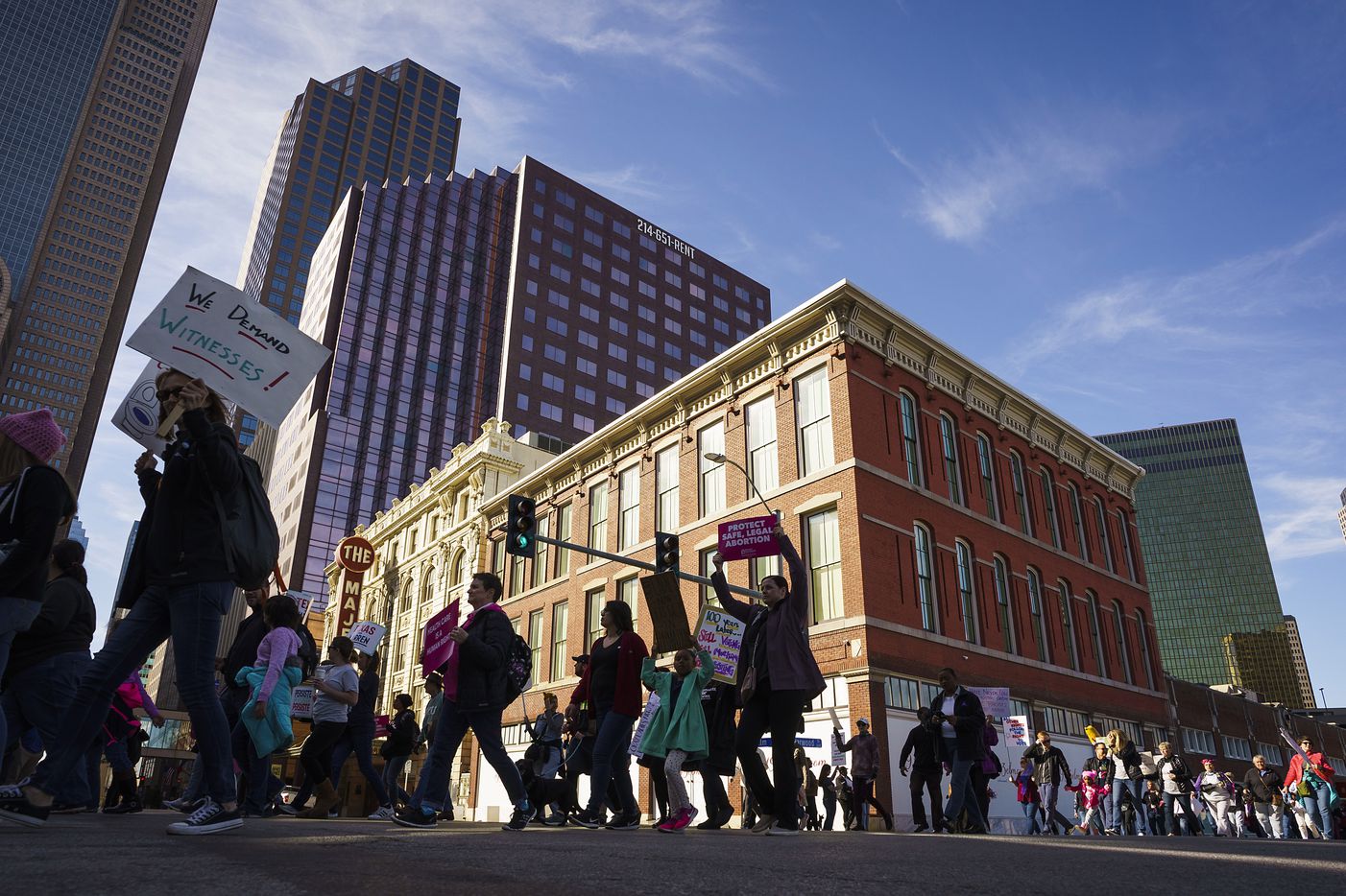 Participants in the 2020 Dallas Women's March walk along Harwood Street on their way to a rally at Dallas City Hall on Sunday, Jan. 19, 2020, in Dallas.
