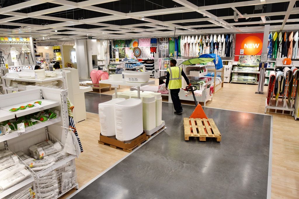 An employee pulls a pallet through the children's section inside the new IKEA furniture...