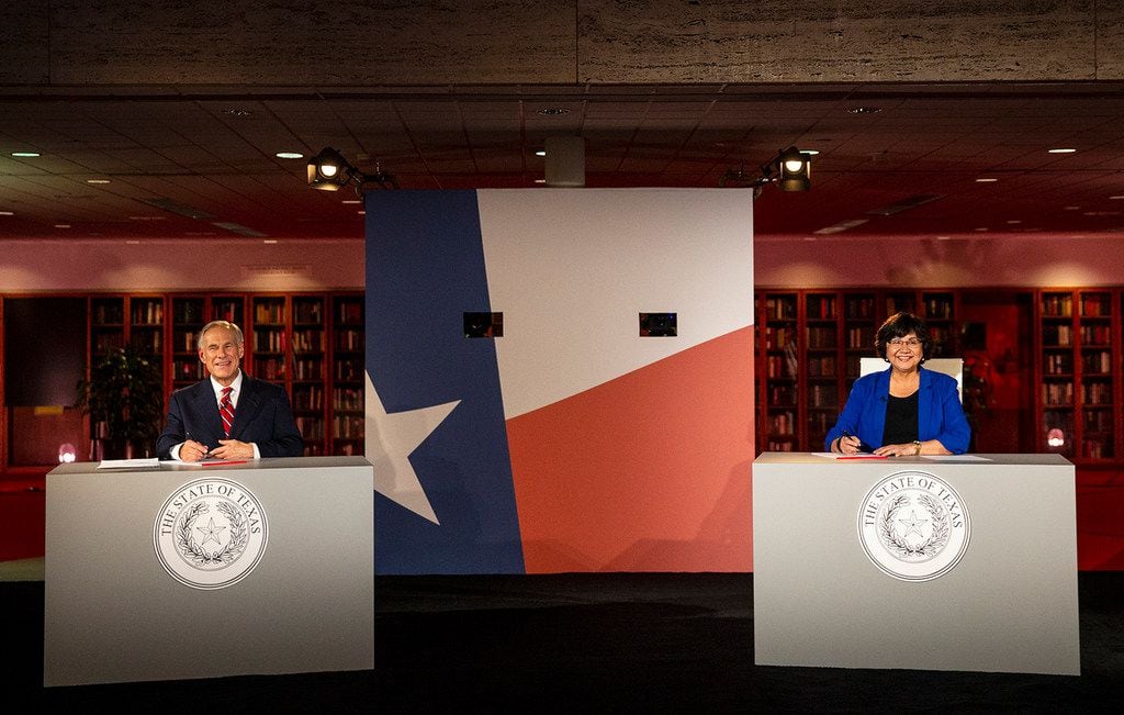 Republican Gov. Greg Abbott and his Democratic challenger, Lupe Valdez, smile before their...