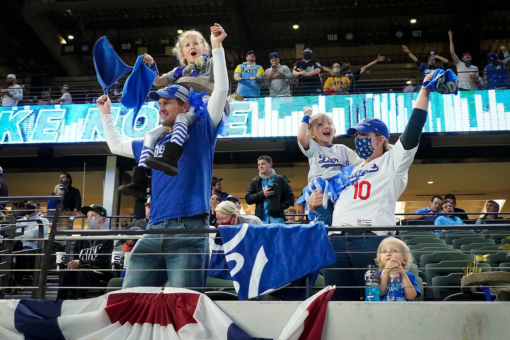 Los Angeles Dodgers fans cheer as their team takes the lead during a 2-run sixth inning...