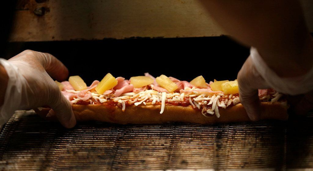A sandwich is placed on the oven at a Which Wich restaurant on Main Street in Dallas,...