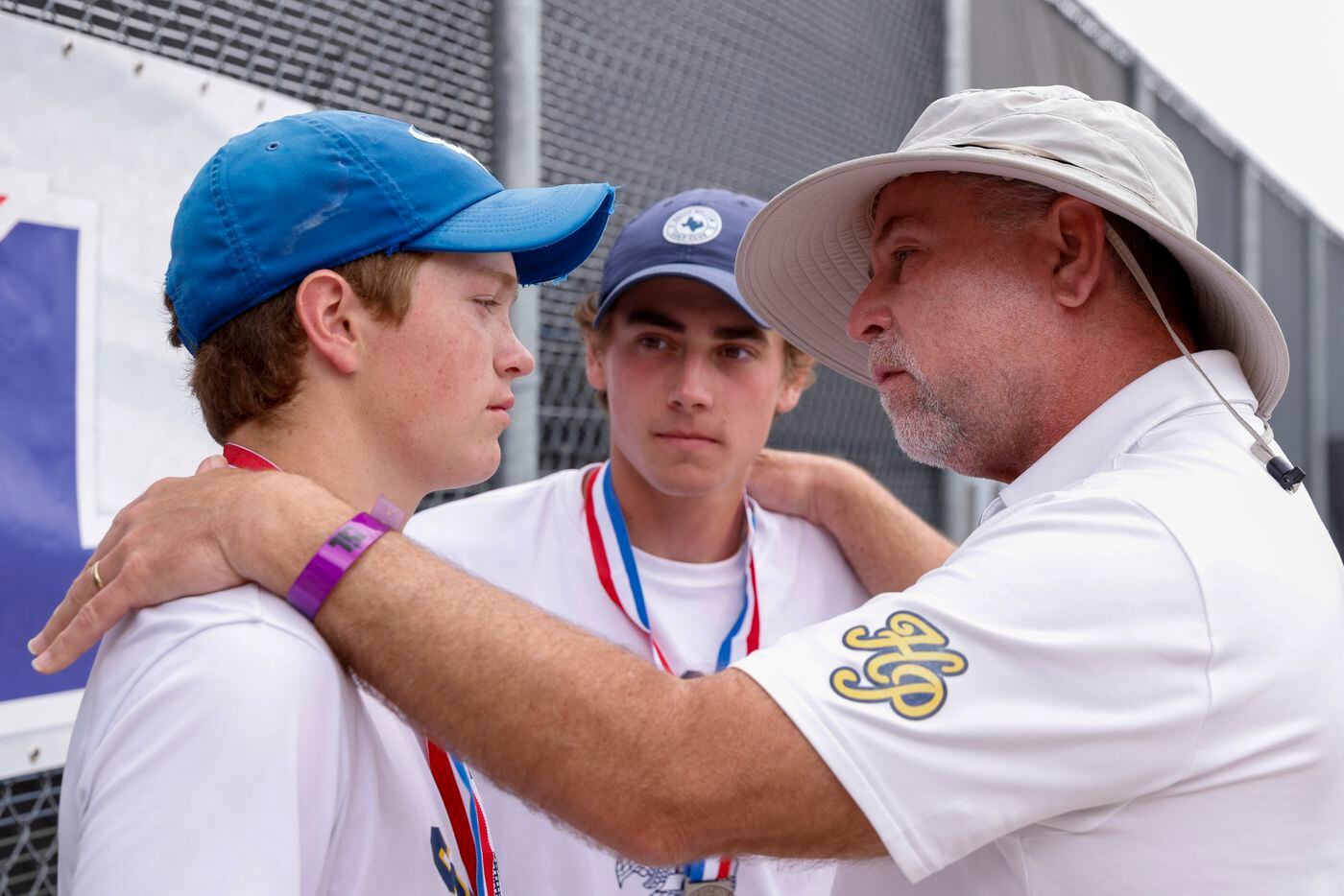 Highland Park head coach Dan Holden (right) speaks with  Ray Saalfield (center) and Carl...