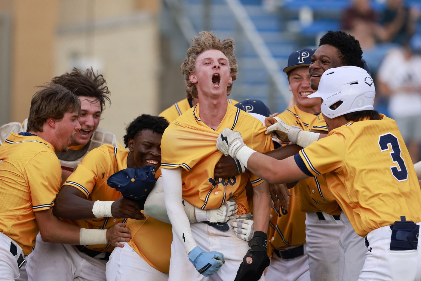 Plano Prestonwood’s Tanner Trout (center) is swarmed by teammates after stealing home in the...