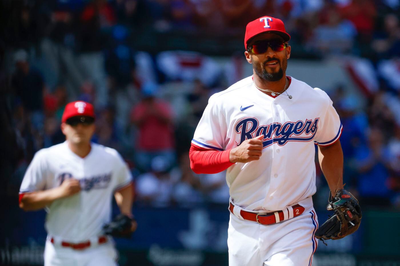 Texas Rangers second baseman Marcus Semien returns to the dugout after tagging Philadelphia...