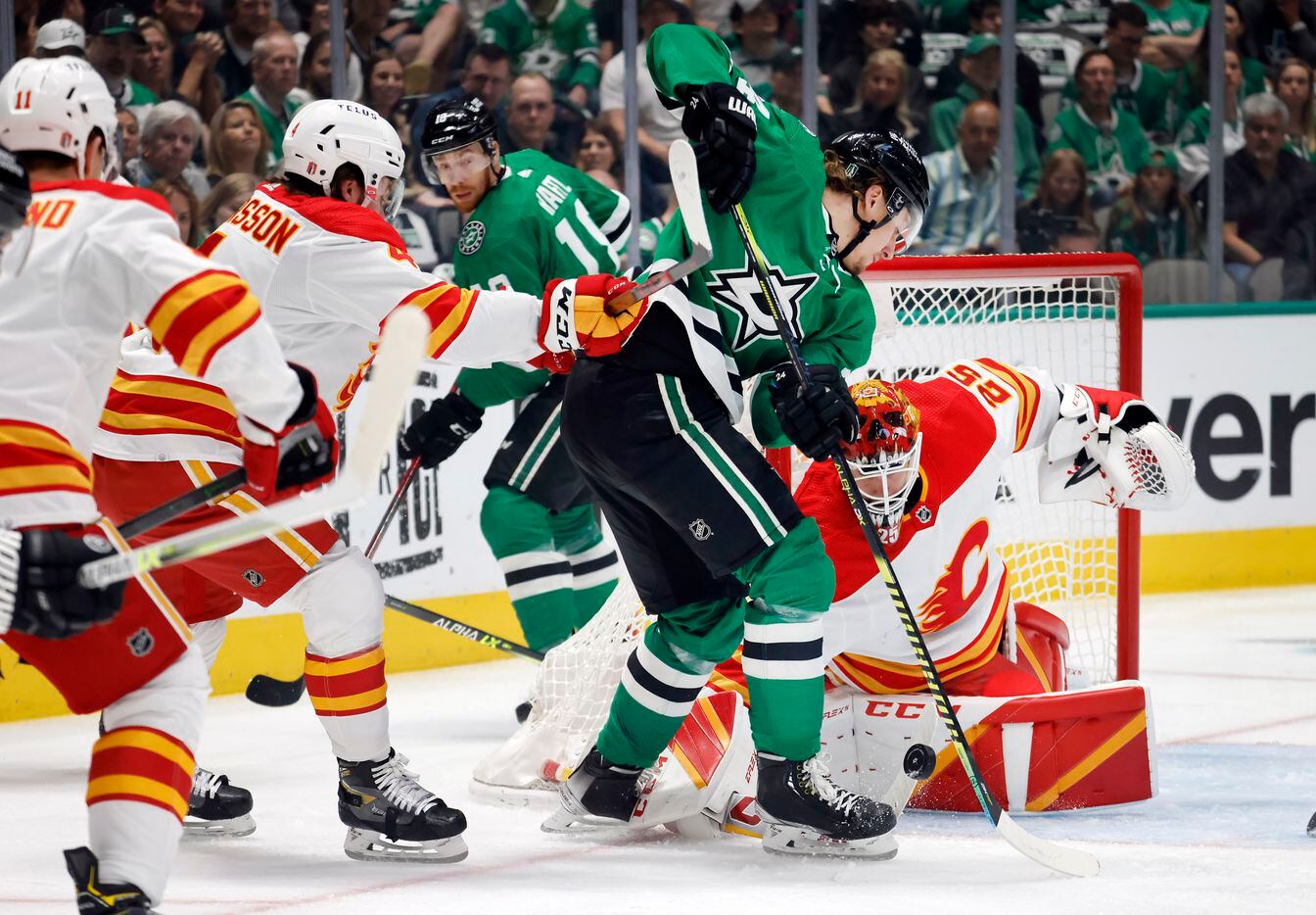 Dallas Stars center Roope Hintz (24) tries to stick the puck past Calgary Flames goaltender...