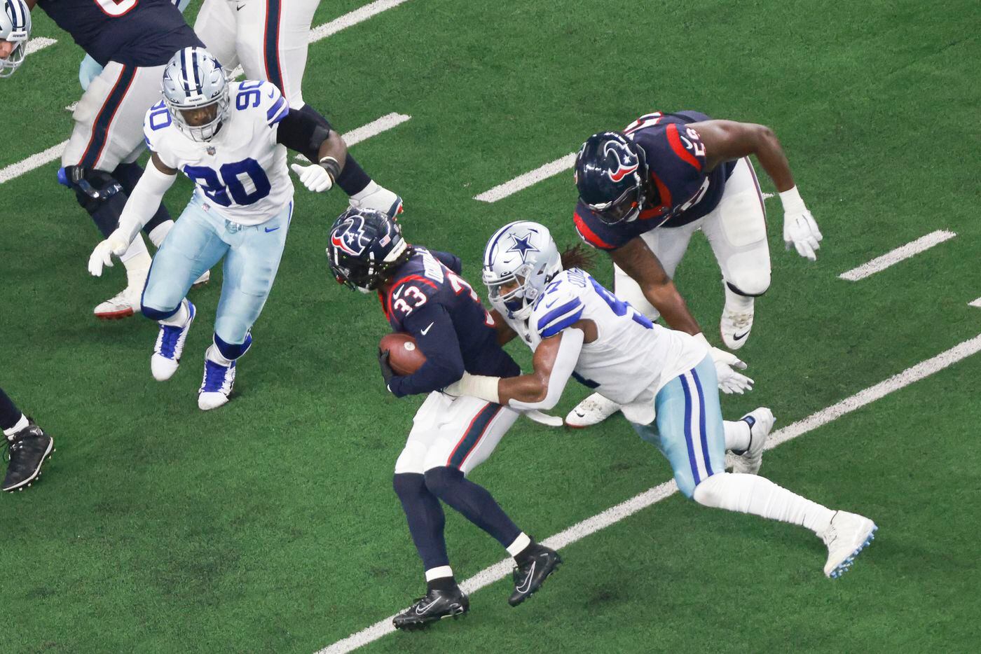 Houston Texans running back Dare Ogunbowale (33) is tackled by Dallas Cowboys defensive...
