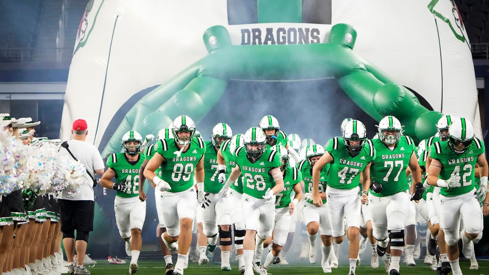 Southlake Carroll players take the field to face Highland Park in a high school football...