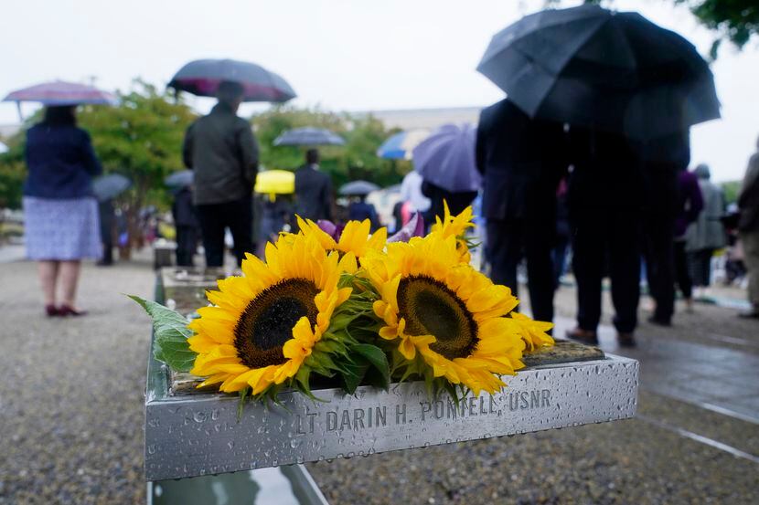 Flowers are visible on one of the benches at the National 9/11 Pentagon Memorial outside the...