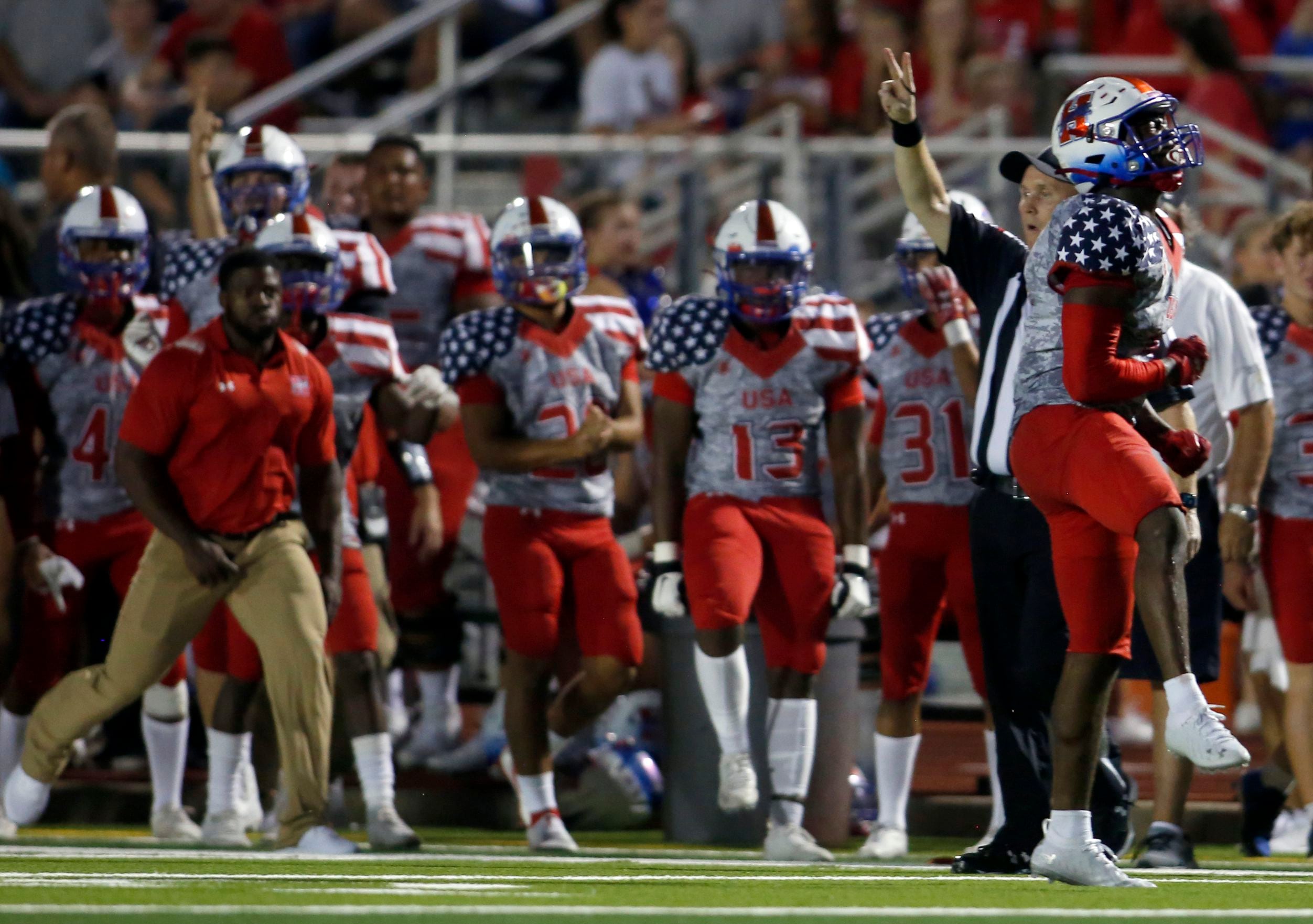 Midlothian Heritage defensive back Greg Johnson (9), far right, reacts after stopping a...